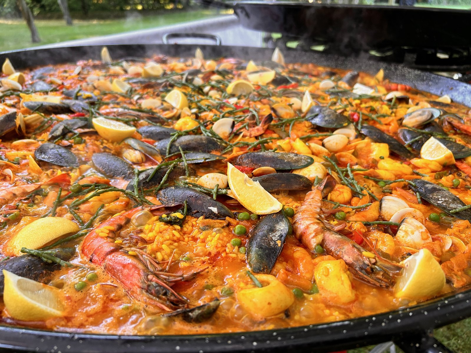 Seafood paella with mussels, prawns and lemon